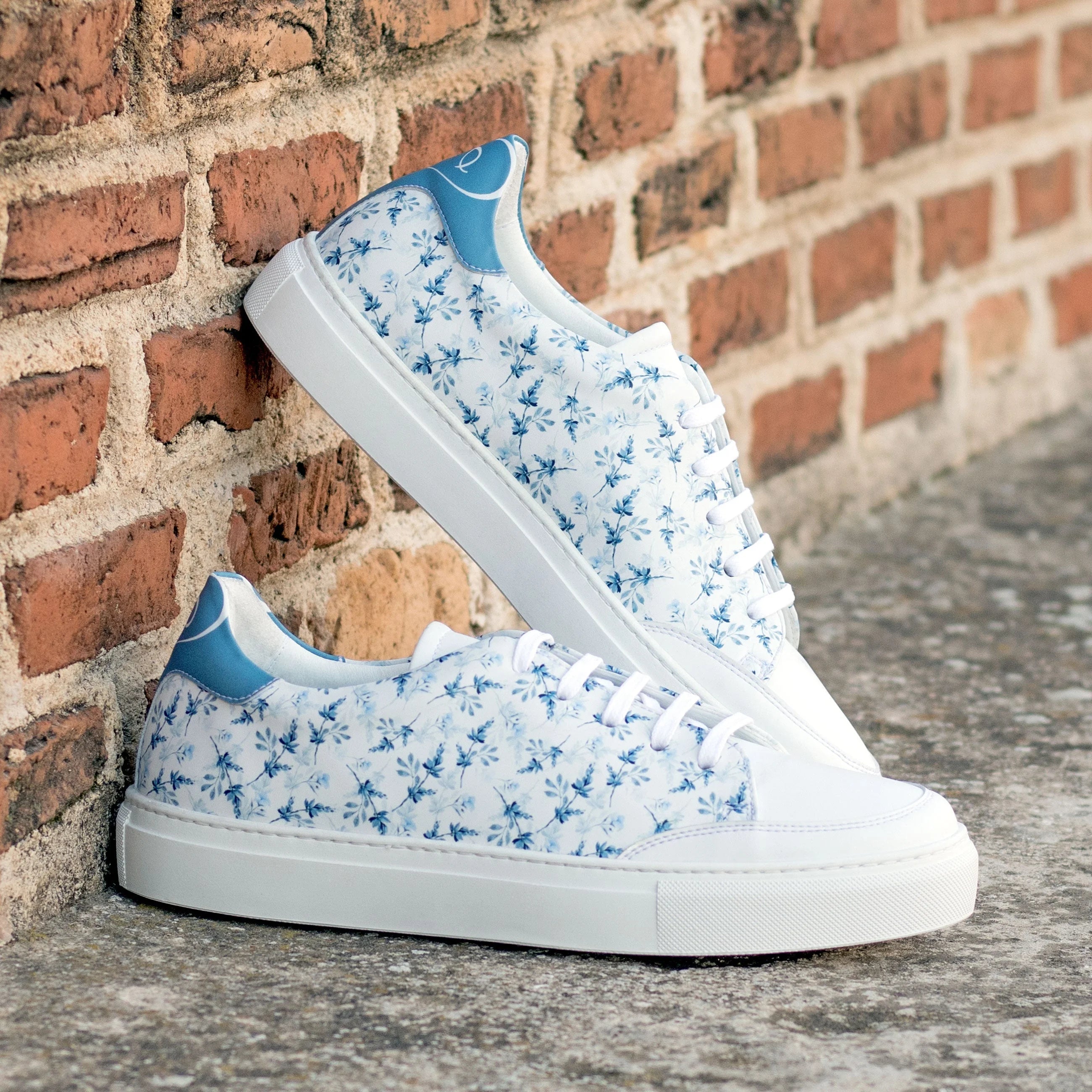 Solarisa unisex trainer in white with blue floral pattern and accents